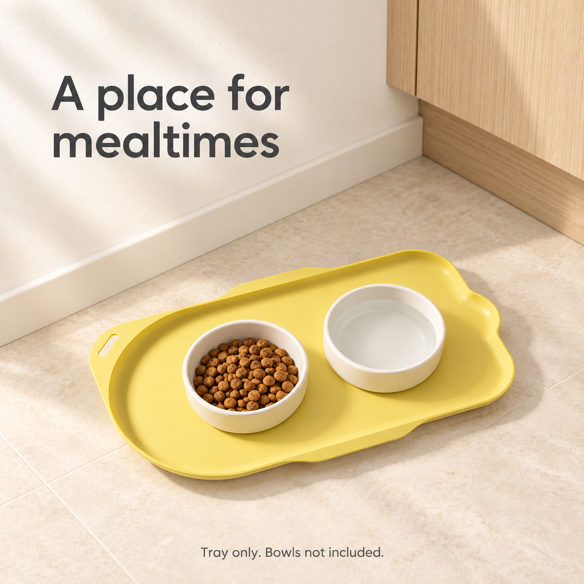 Yellow cat-shaped feeding tray with food and water bowls in a kitchen feeding area. Tray only; bowls not included.