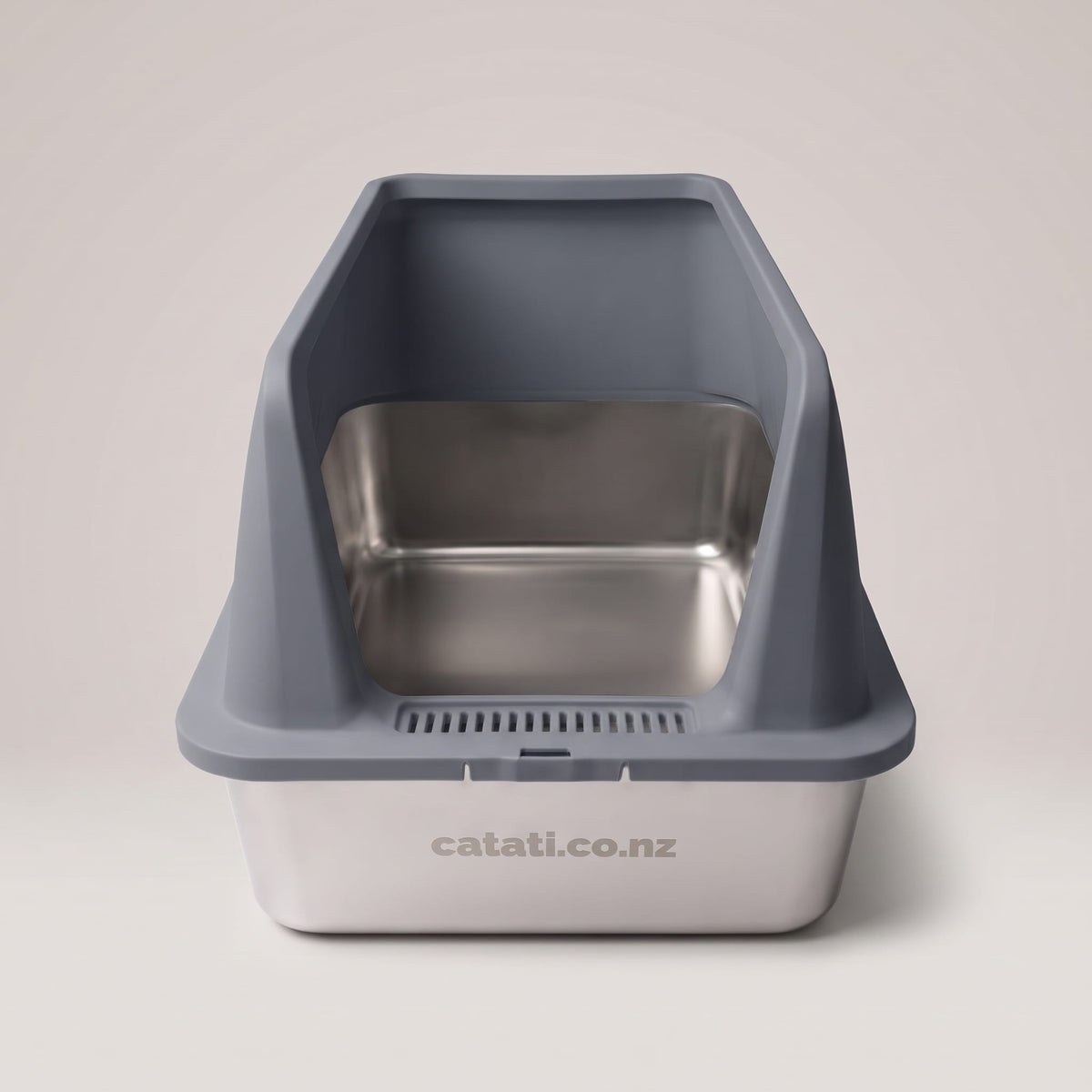 Front view of the grey stainless steel cat litter box, showing the slotted entry and engraved catati.co.nz mark