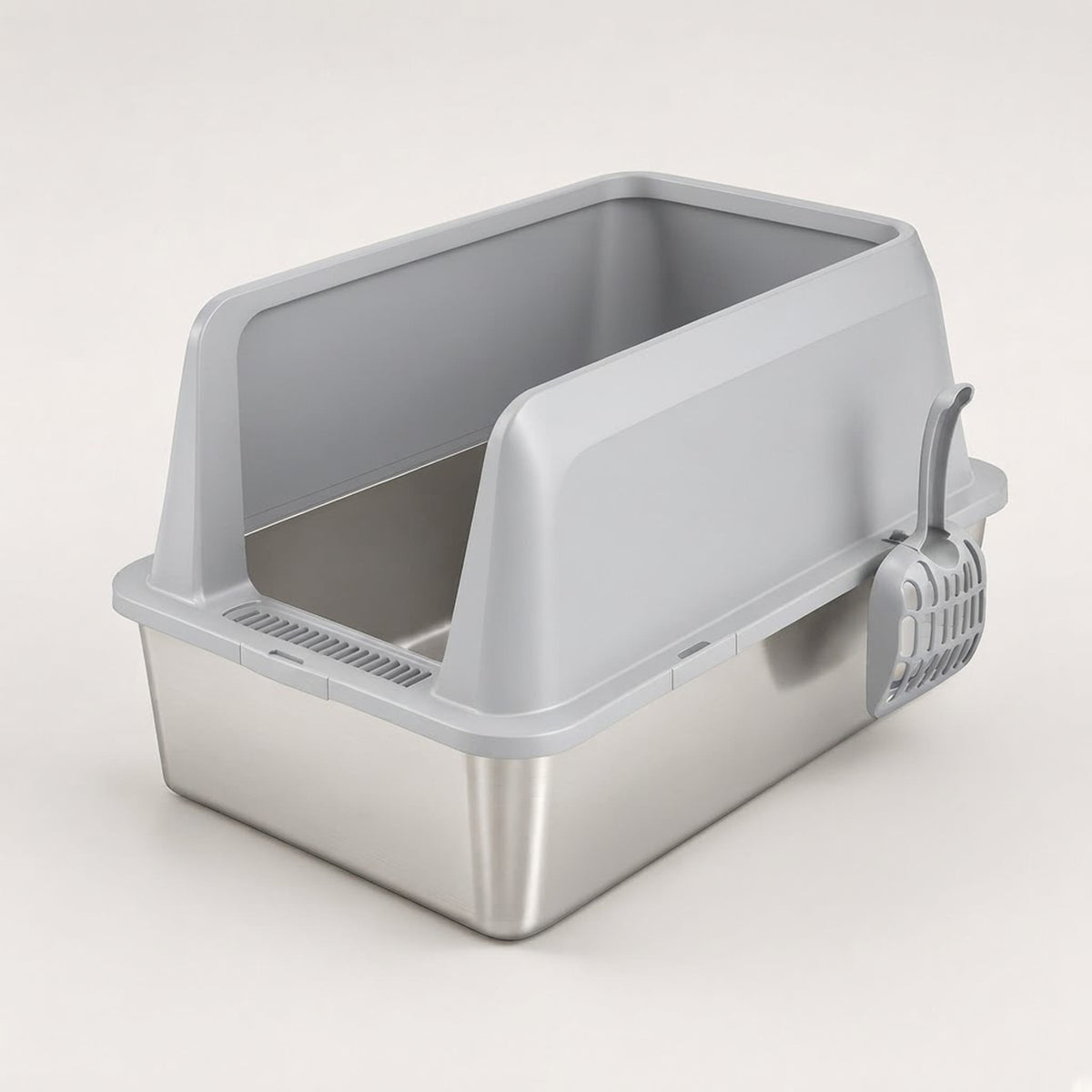 Silver stainless steel cat litter box with high sides and a scoop clipped on, three-quarter view