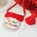 Red Happy Birthday cat bib and red pom-pom party hat with an adjustable white cord.