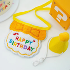 Yellow Happy Birthday cat bib and yellow pom-pom party hat with an adjustable white cord.