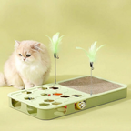 Cream-coloured cat beside a green scratcher activity toy with feather teasers and balls.